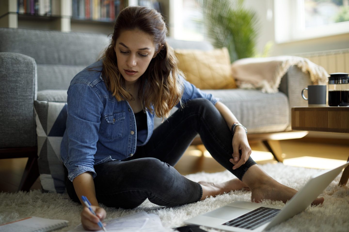 Woman calculating finances at home