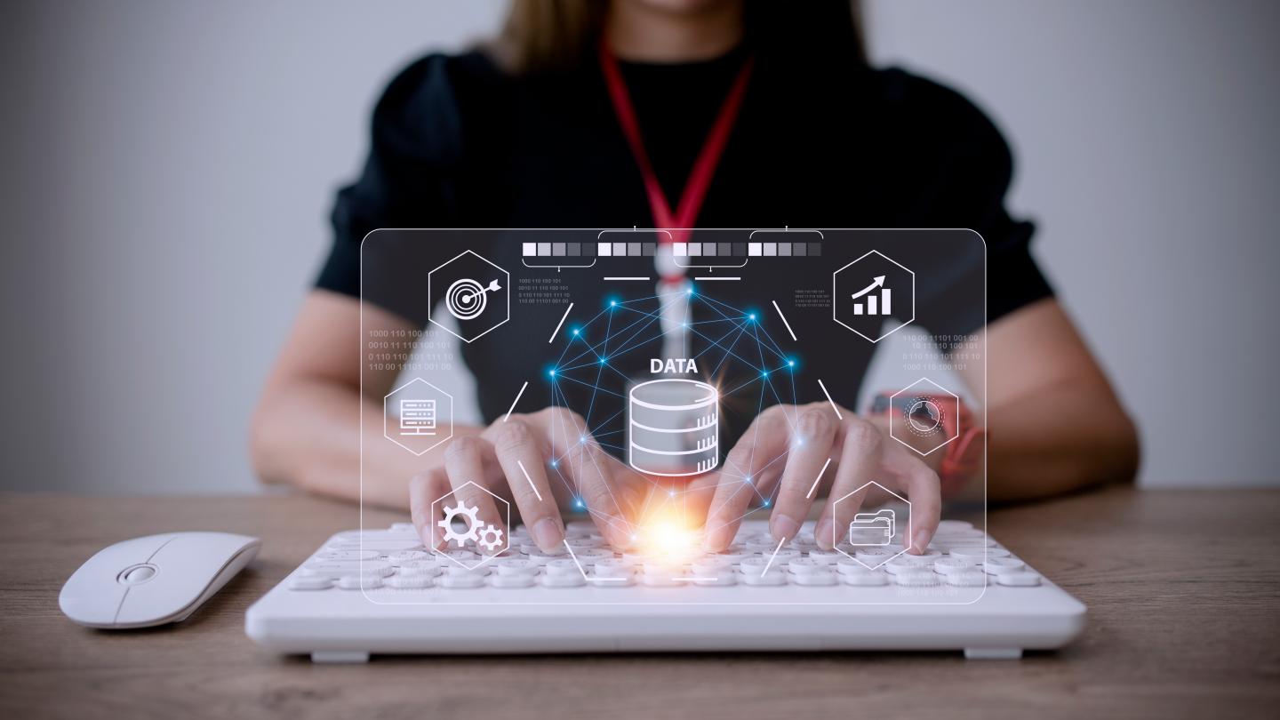 Big data and analytics visualization technology with scientist analyzing information structure on screen with machine learning to extract predictions for business, finance, internet of things