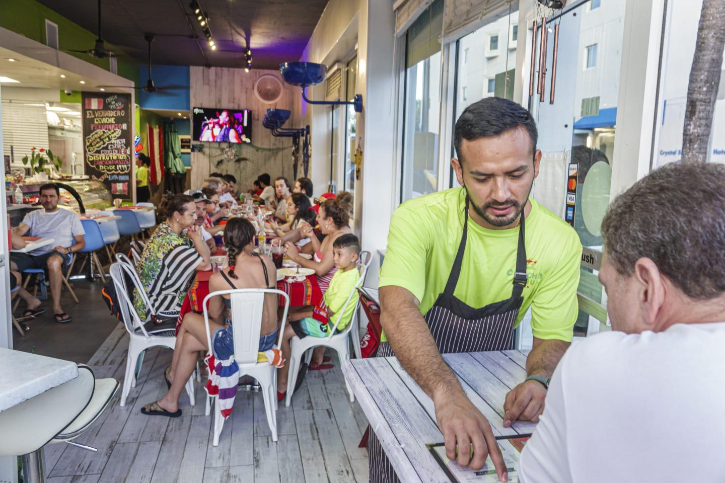 Waiter and patron at restaurant