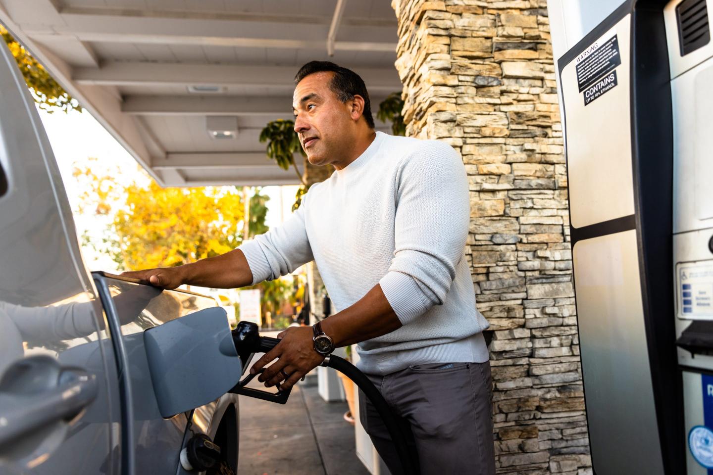 man pumping gas