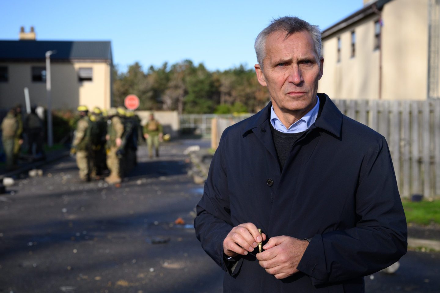 Secretary General of NATO Jens Stoltenberg holds a round of blank ammunition after observing Ukrainian troops being trained in southeast England in November.