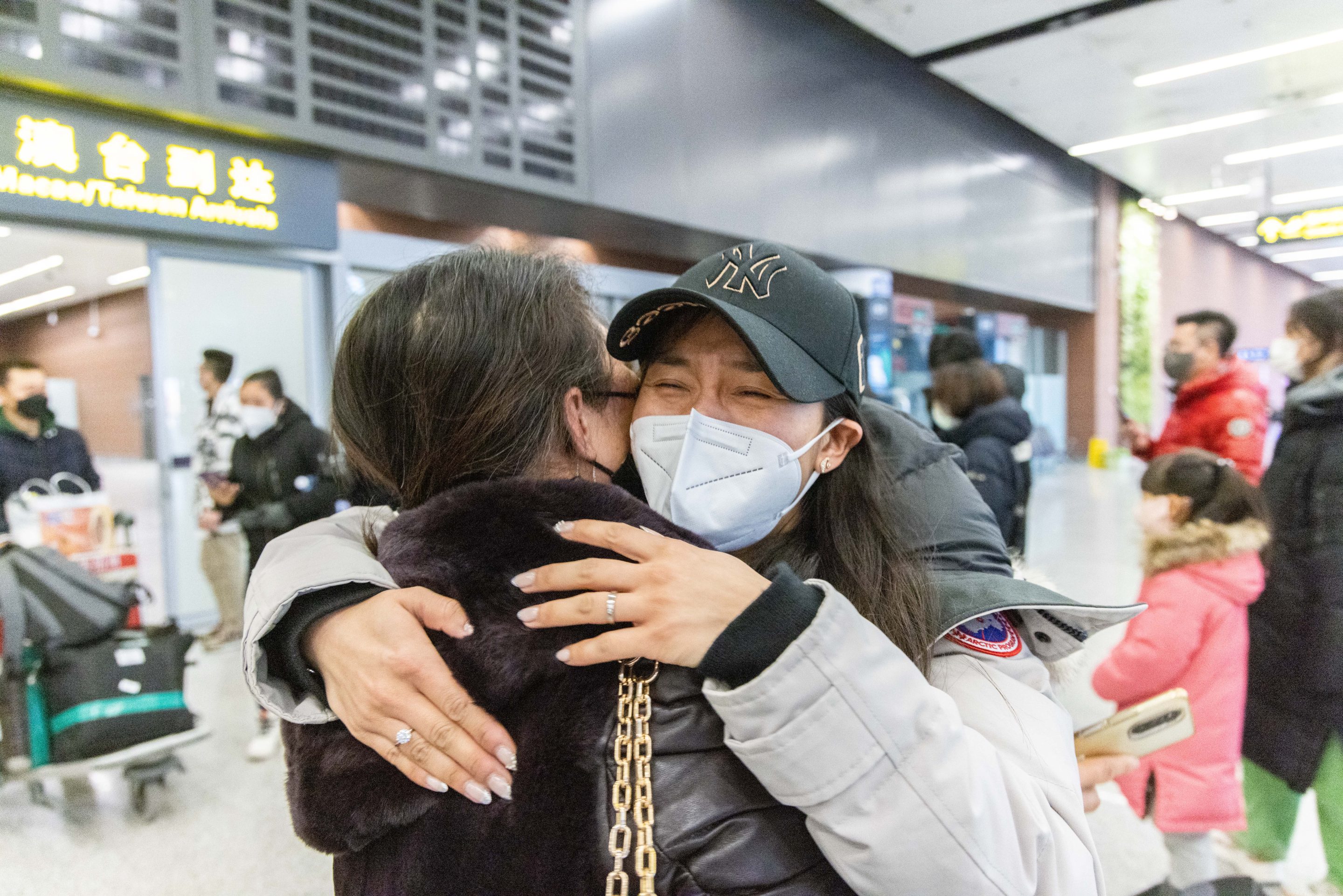 A family embraces in Shenyang airport after China removes quarantines