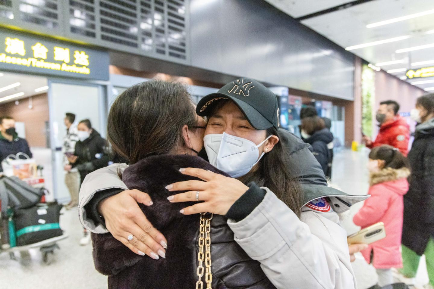 A family embraces in Shenyang airport after China removes quarantines