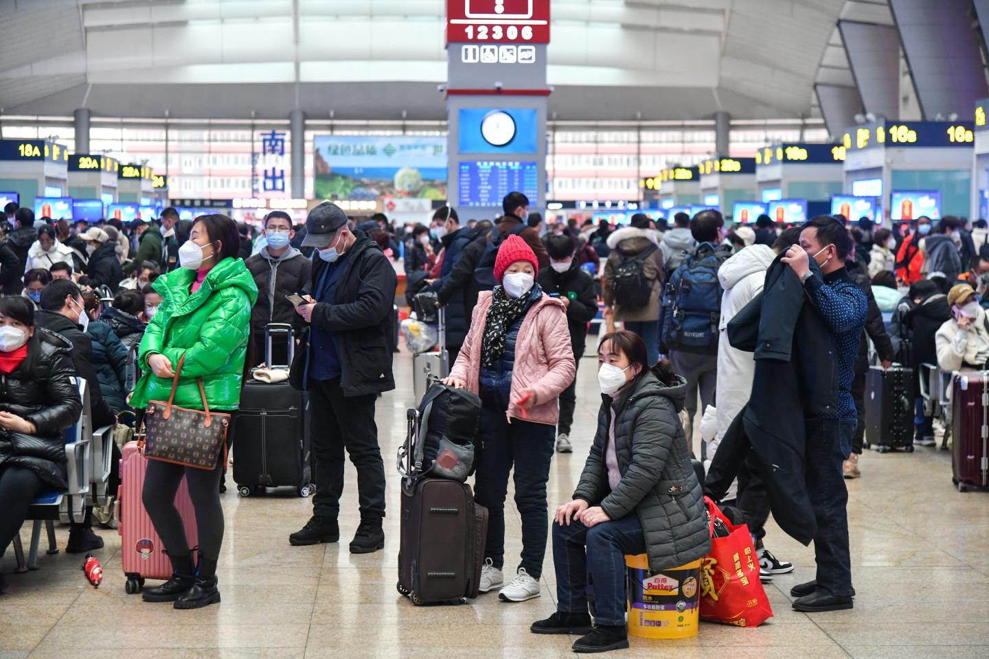 Passengers wait for the train in Beijing's train station around Chinese New Year.