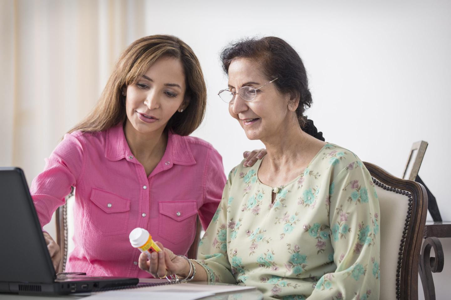A mother and daughter doing research online together about medications