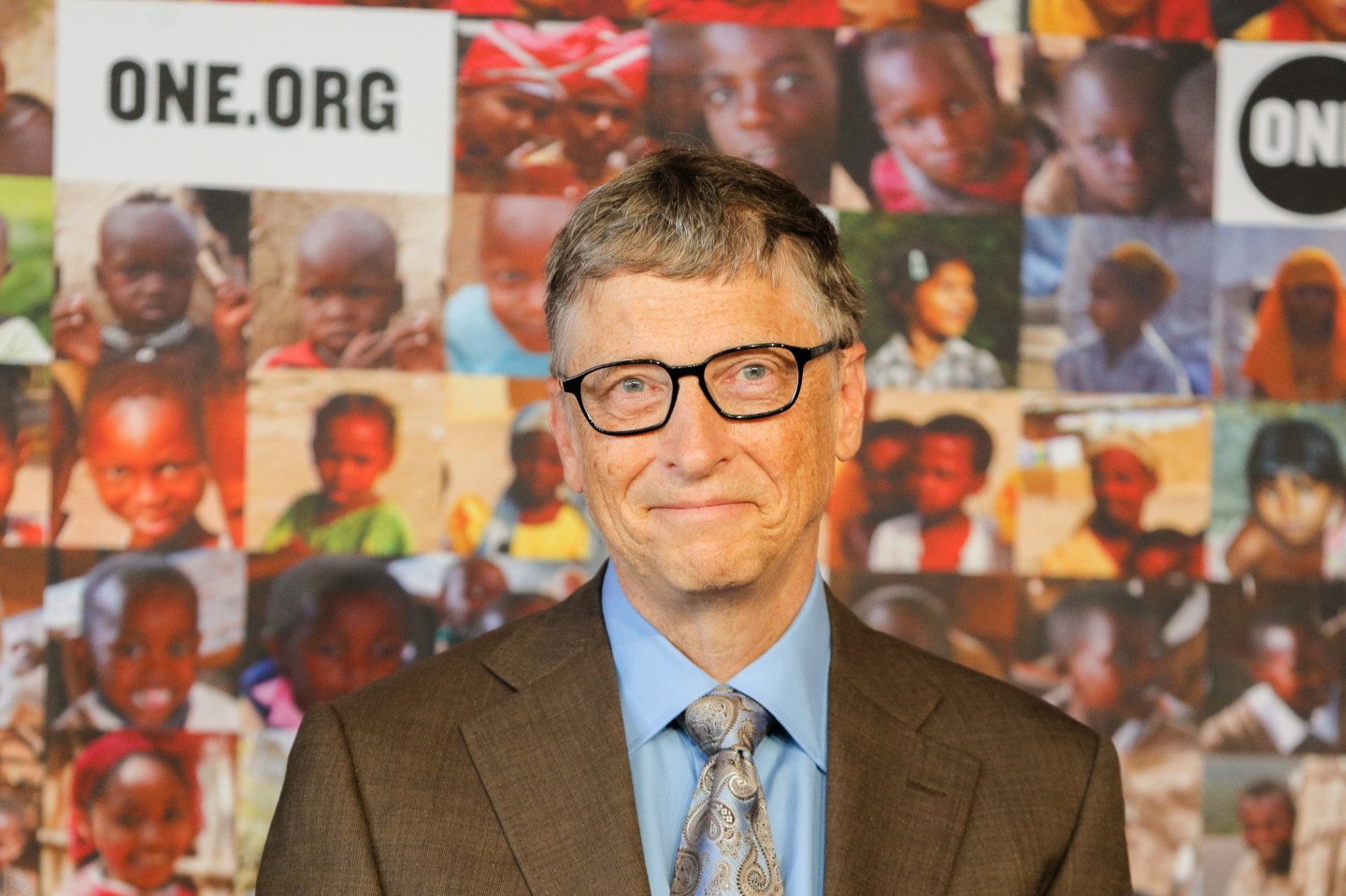 Bill Gates smiling at the camera while attending a 2014 press conference in Berlin