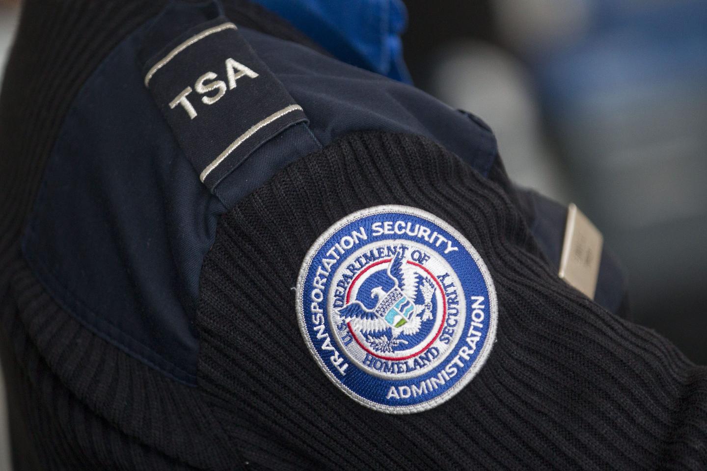 A Transportation Security Administration (TSA) officer works at a security checkpoint