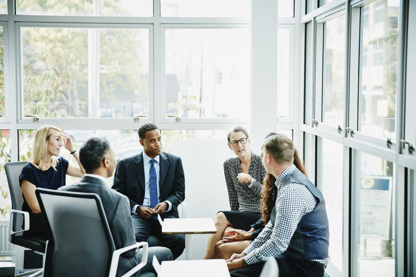 Mature businesswoman leading meeting
