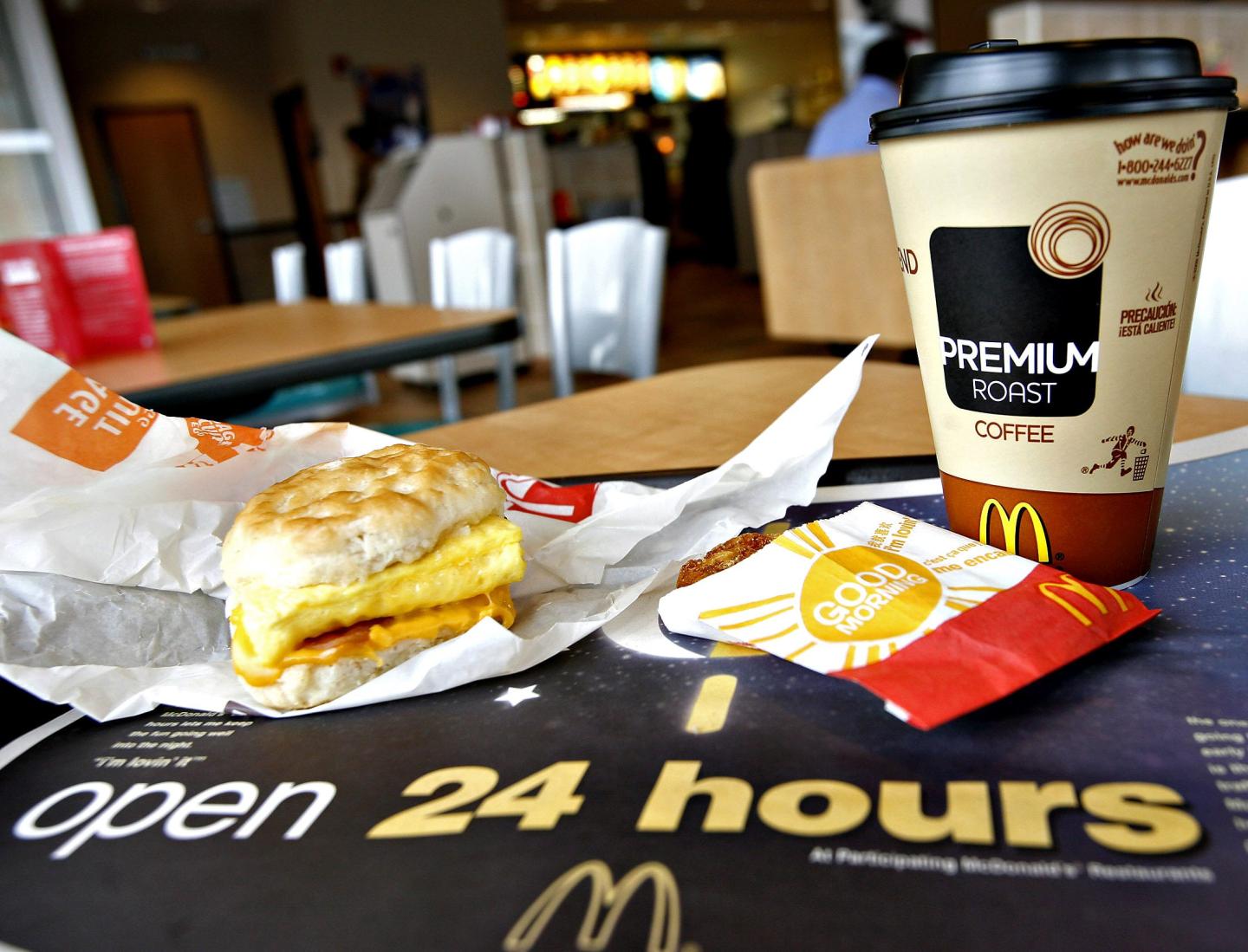 A sausage Egg McMuffin meal with hash browns and coffee