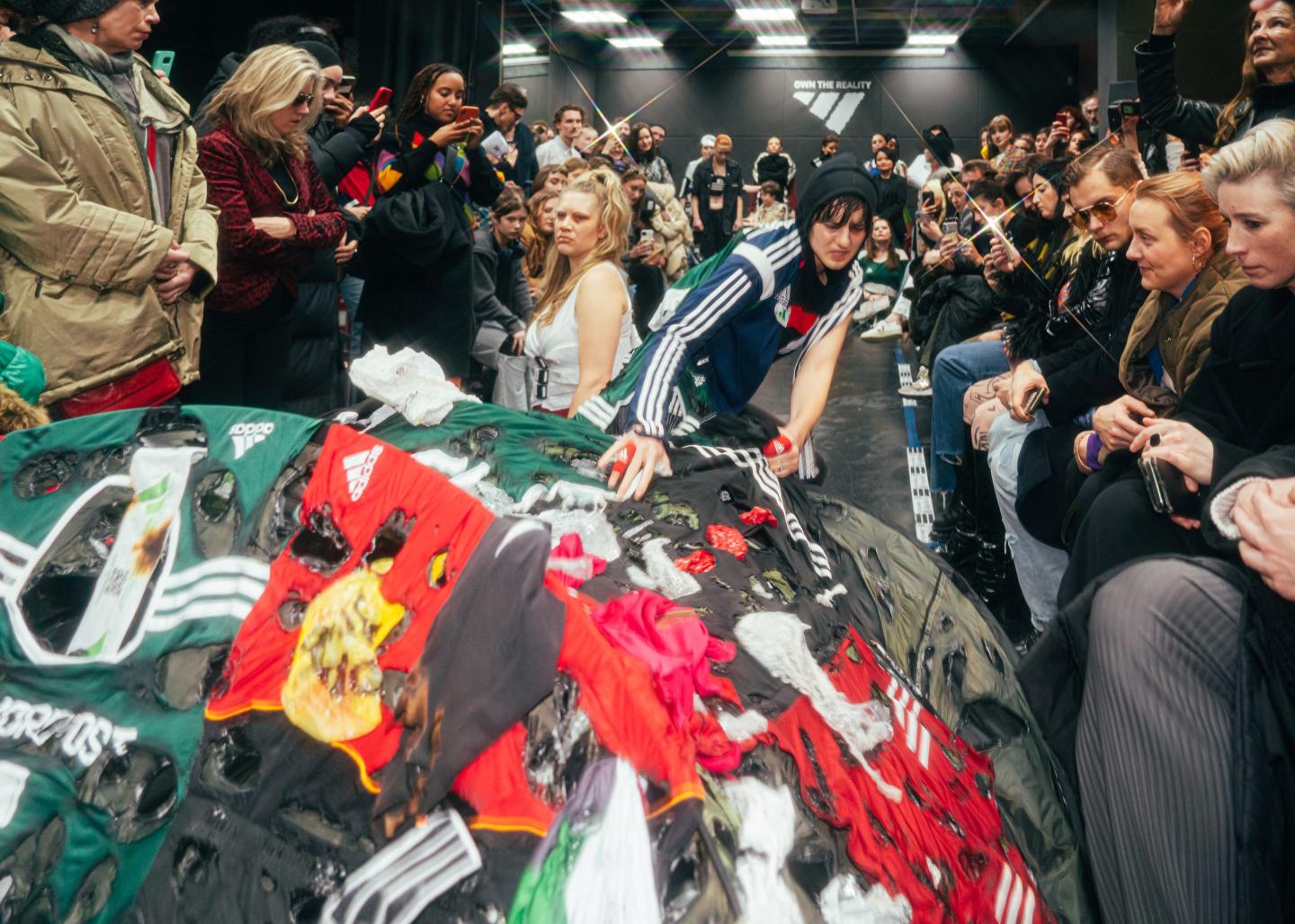 Shocked viewers watch two models on the catwalk at Berlin Fashion Week