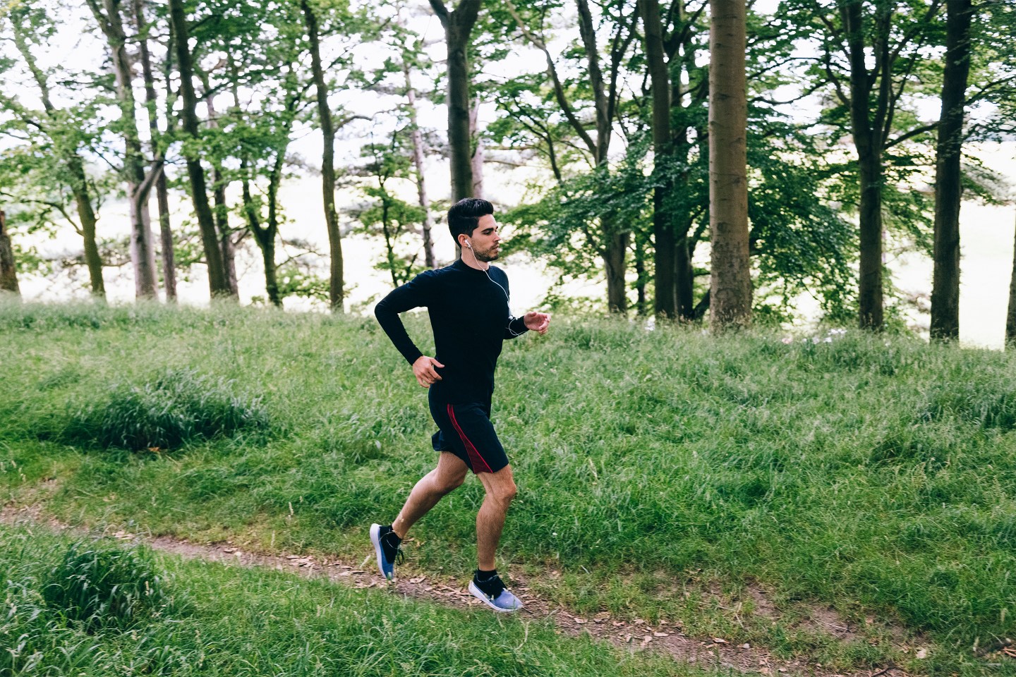 Man running on forest track.