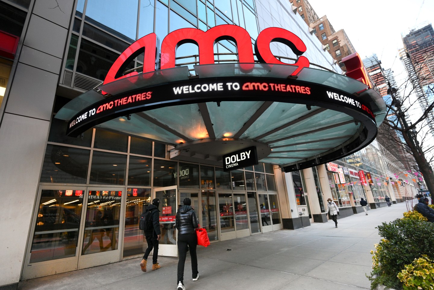 People walk by the AMC 34th Street theater on March 5, 2021, in New York.