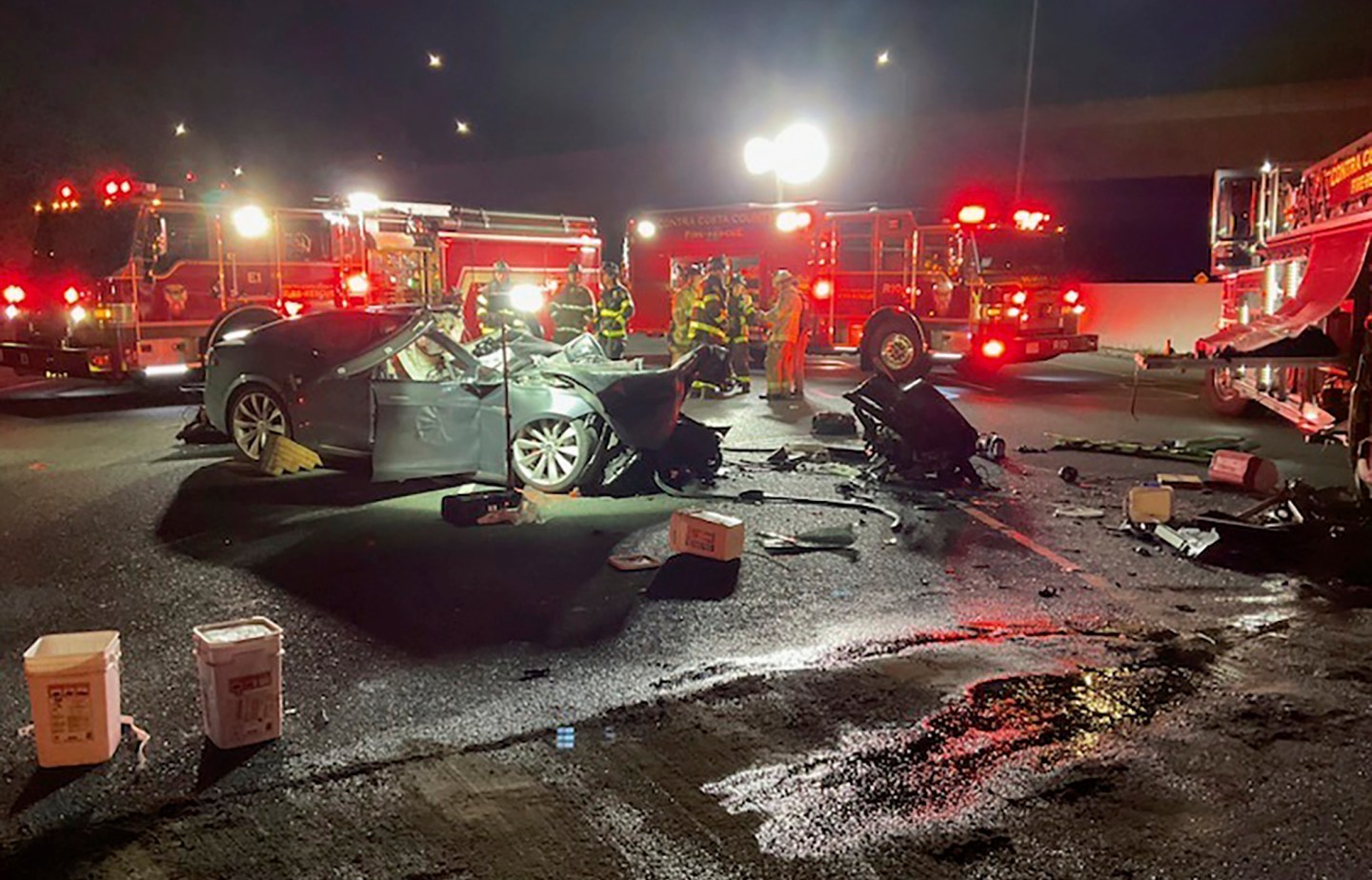 Firefighters work the scene of a fatal accident involving a Tesla and Contra Costa County fire truck early Saturday morning, Feb. 18, 2023, in Contra Costa, Calif.