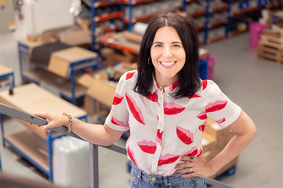 The founder stands in her warehouse