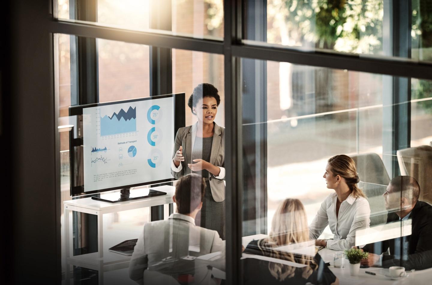 Photo of a businesswoman delivering a presentation to her colleagues in the boardroom
