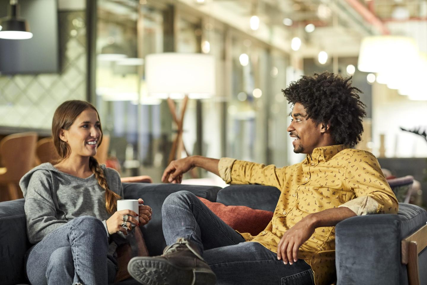Coworkers talking on modern couch