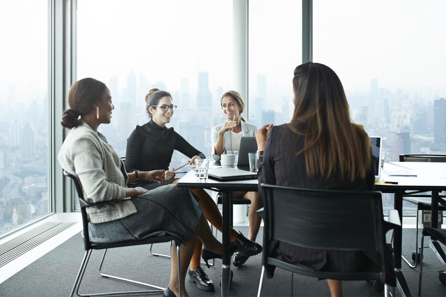Business people in large modern meeting room