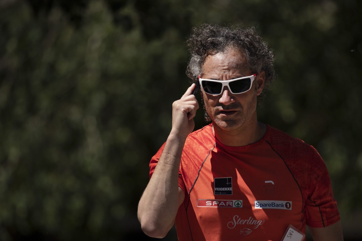 Plantir Technologies CEO Alex Karp on the phone wearing sports sunglasses
