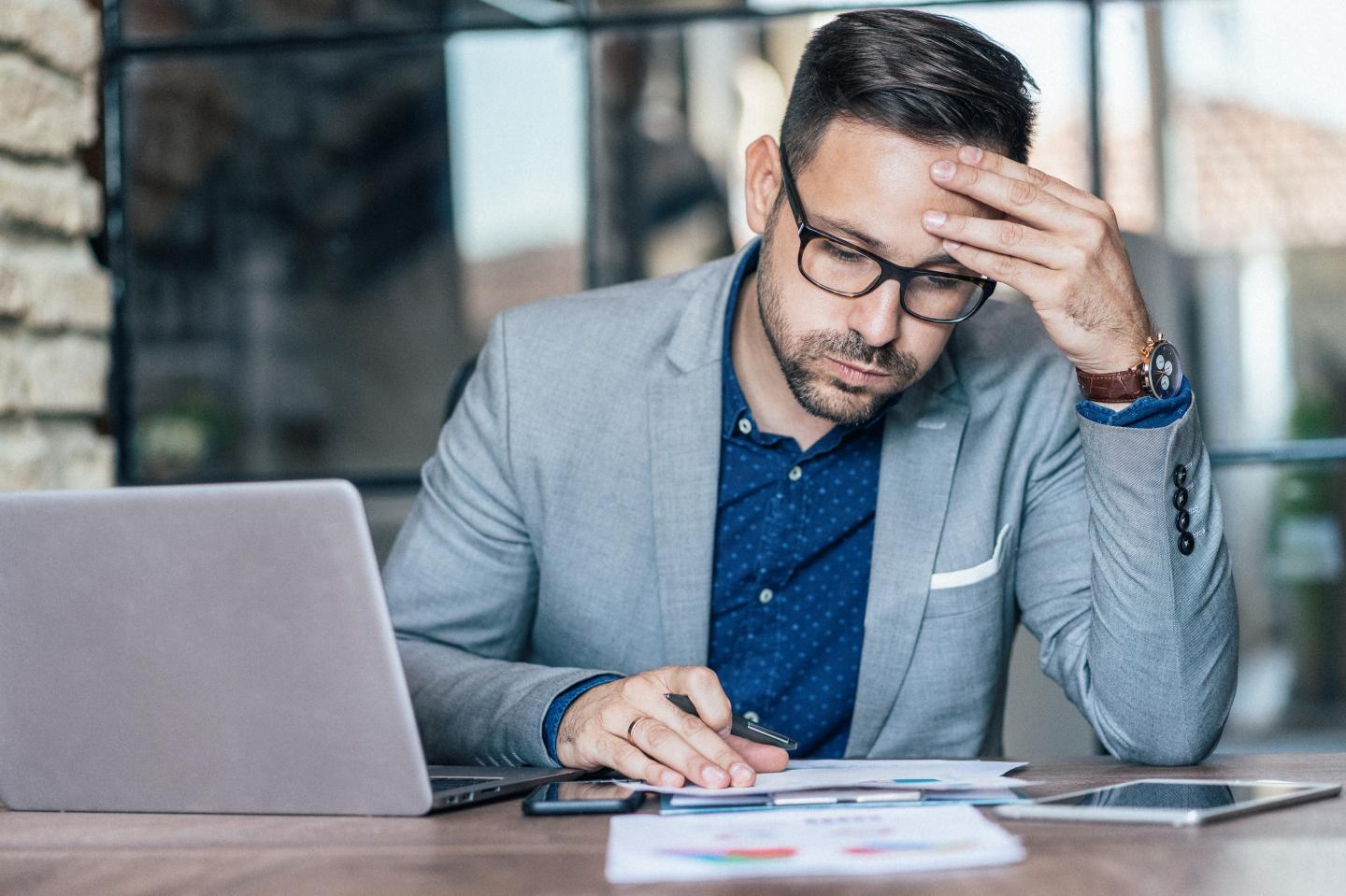 A tired businessman looking anxious.
