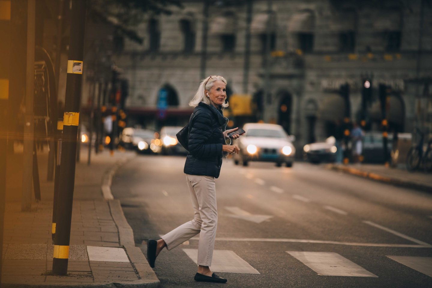 Senior woman crossing road in city