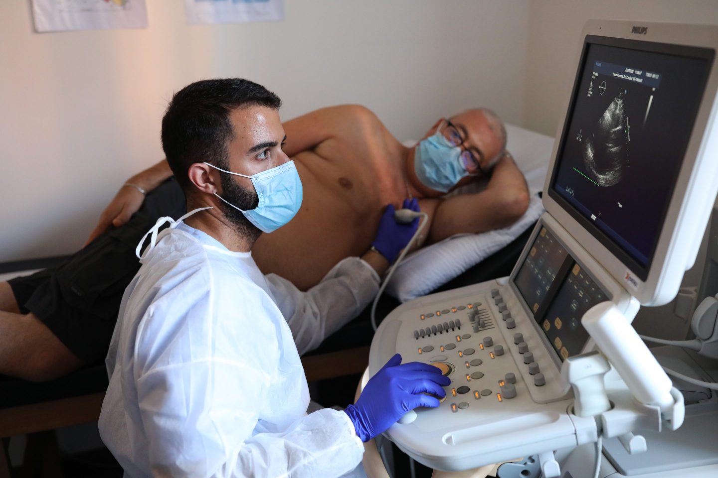 Roberto Bruzzone, 57, watches during his ultrasound in Genova, Italy, in July 2020. Even a mild case of COVID can lead to an increased risk of cardiac issues.