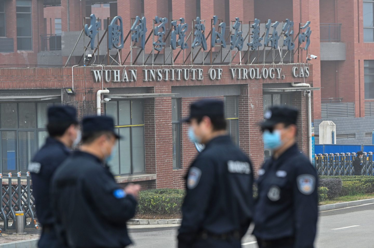 Security personnel stand guard outside the Wuhan Institute of Virology in February 2021 during a visit from a World Health Organization (WHO) team investigating the origins of the COVID-19 coronavirus.