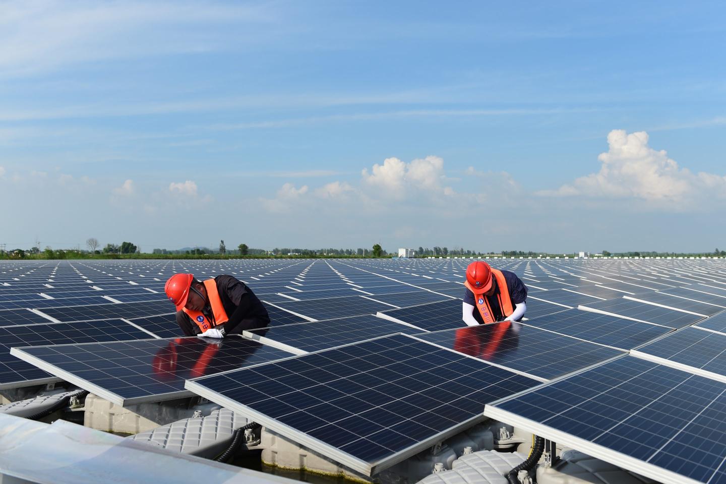 Engineers doing maintenance work at a solar farm in China