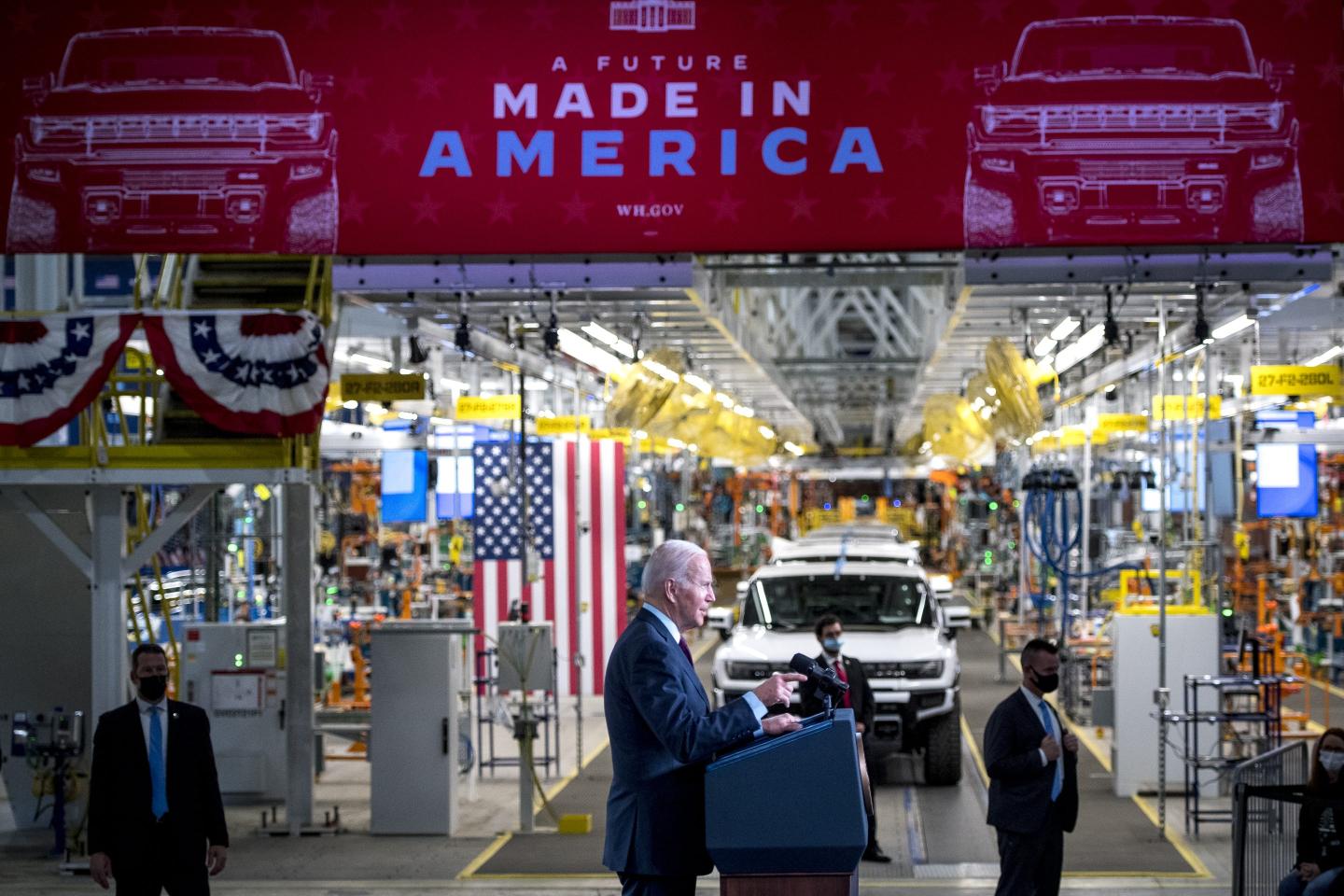 A picture of President Joe Biden at an electric vehicle assembly factory.