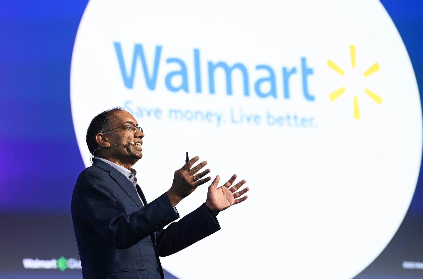 Walmart CTO Suresh Kumar in front of a Walmart logo