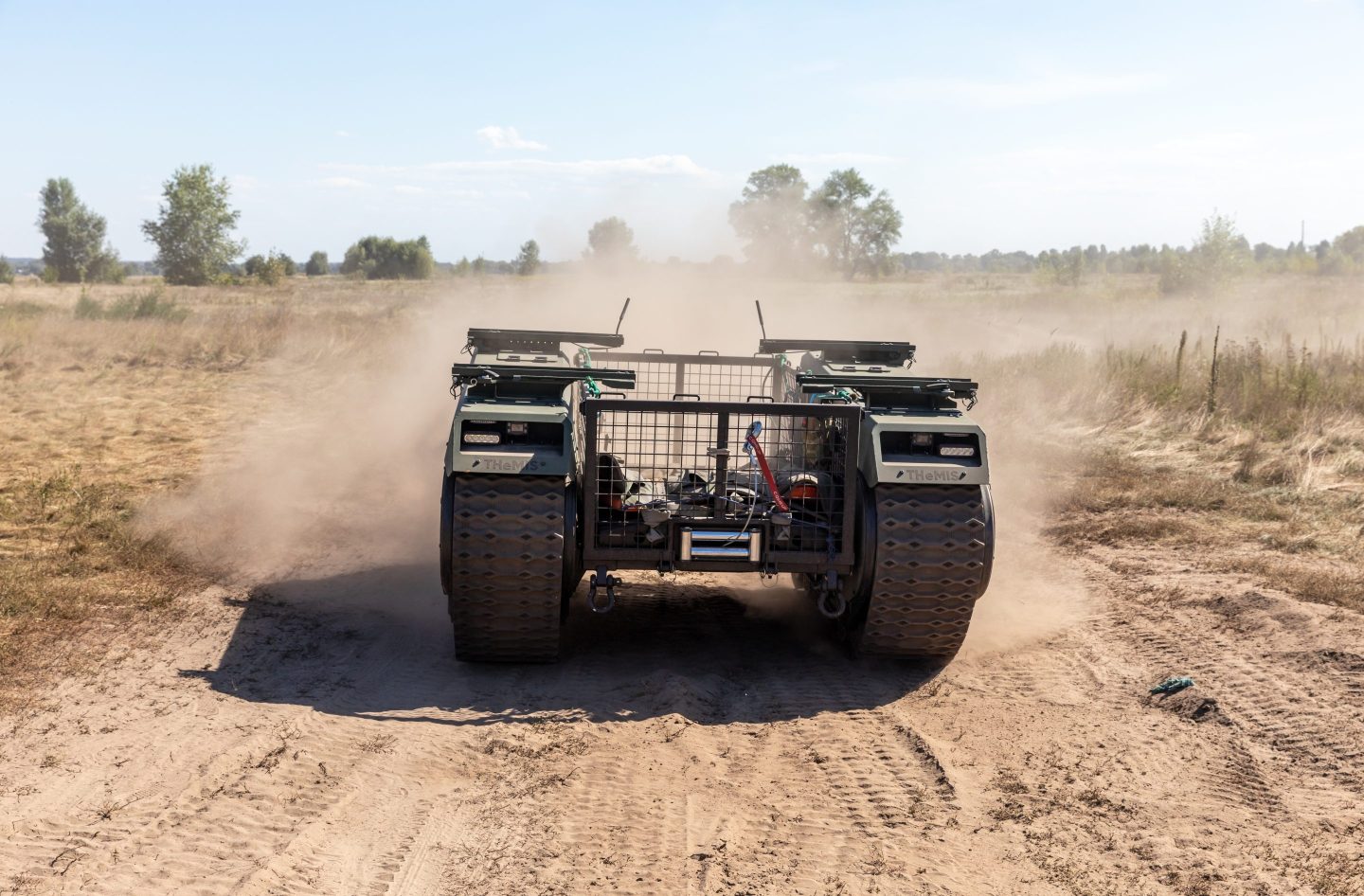 Evacuation robot (unmanned ground vehicle) THeMIS seen on a dusty road during the field tests.
