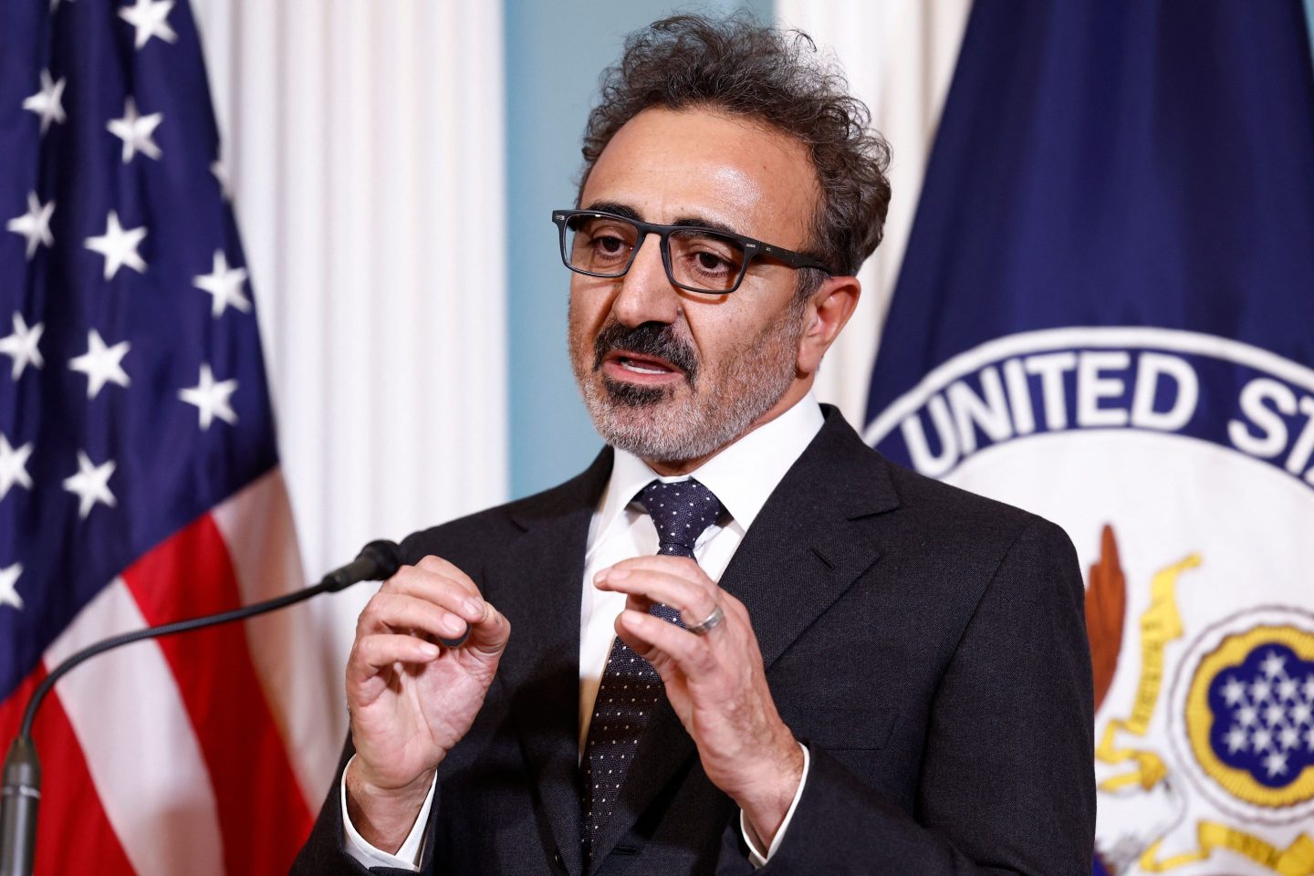 A picture of Hamdi Ulukaya speaking on a microphone