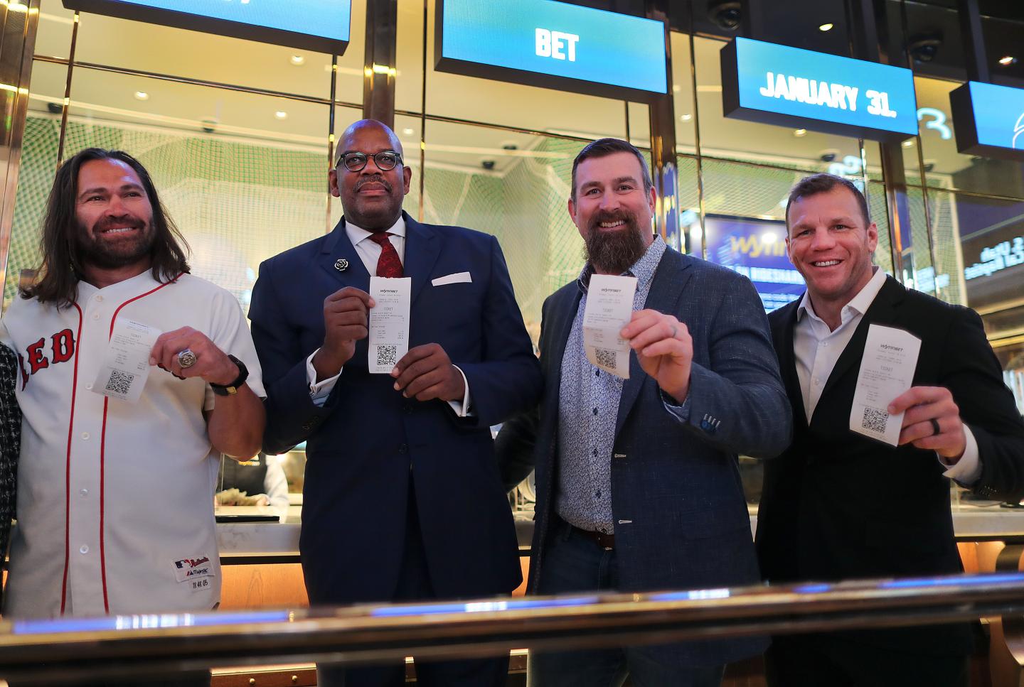 Four sports celebrities standing together.