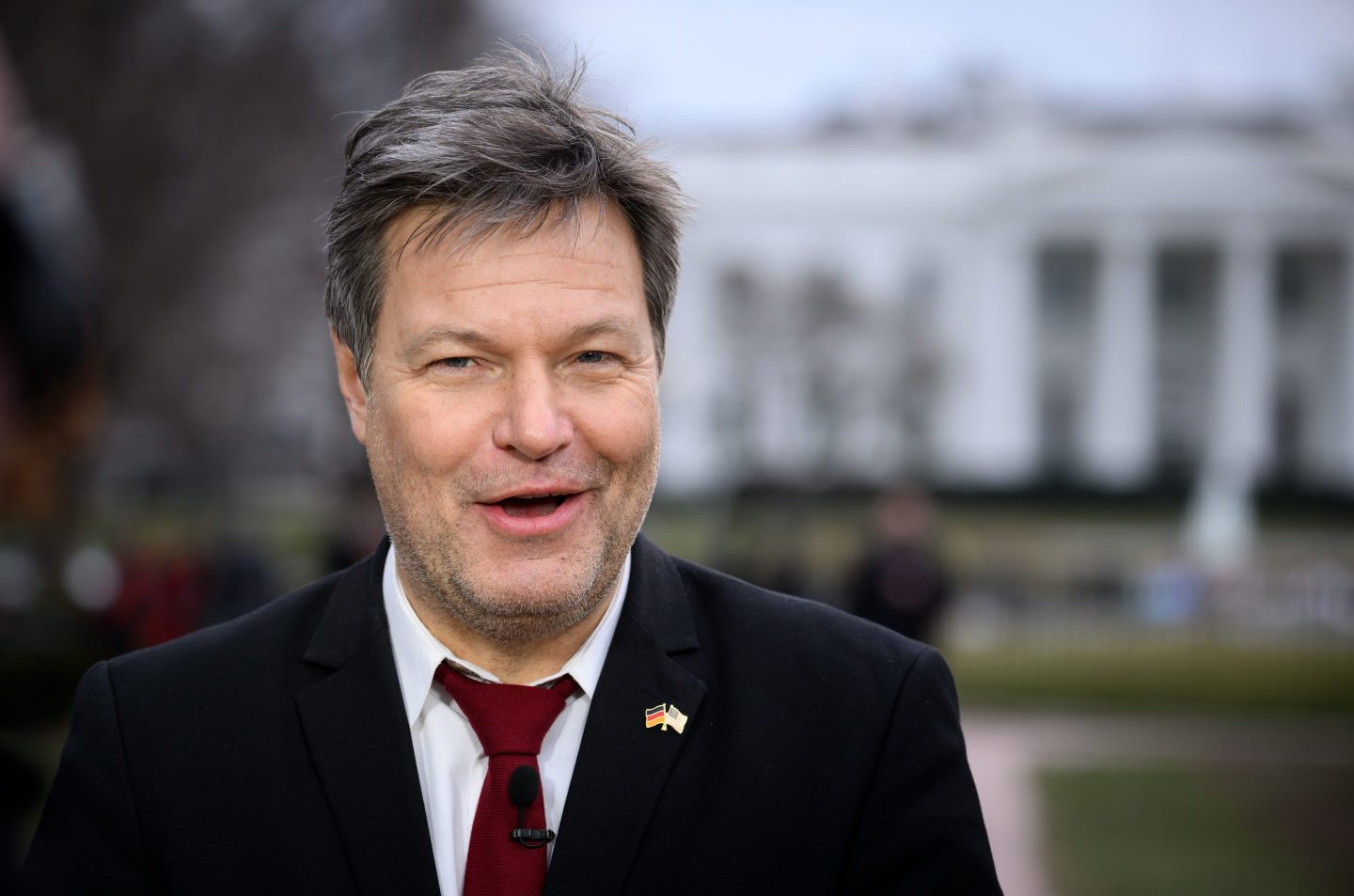 Robert Habeck, Germany's federal minister for economic affairs and climate protection, stands in front of the White House during a TV interview.