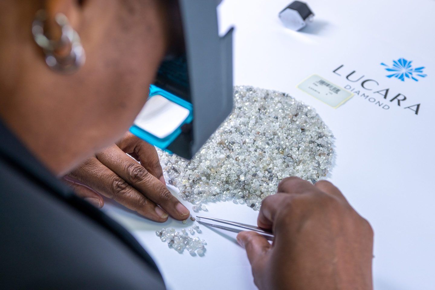 An employee inspects rough diamonds at a Lucara Diamond sales center in Botswana.