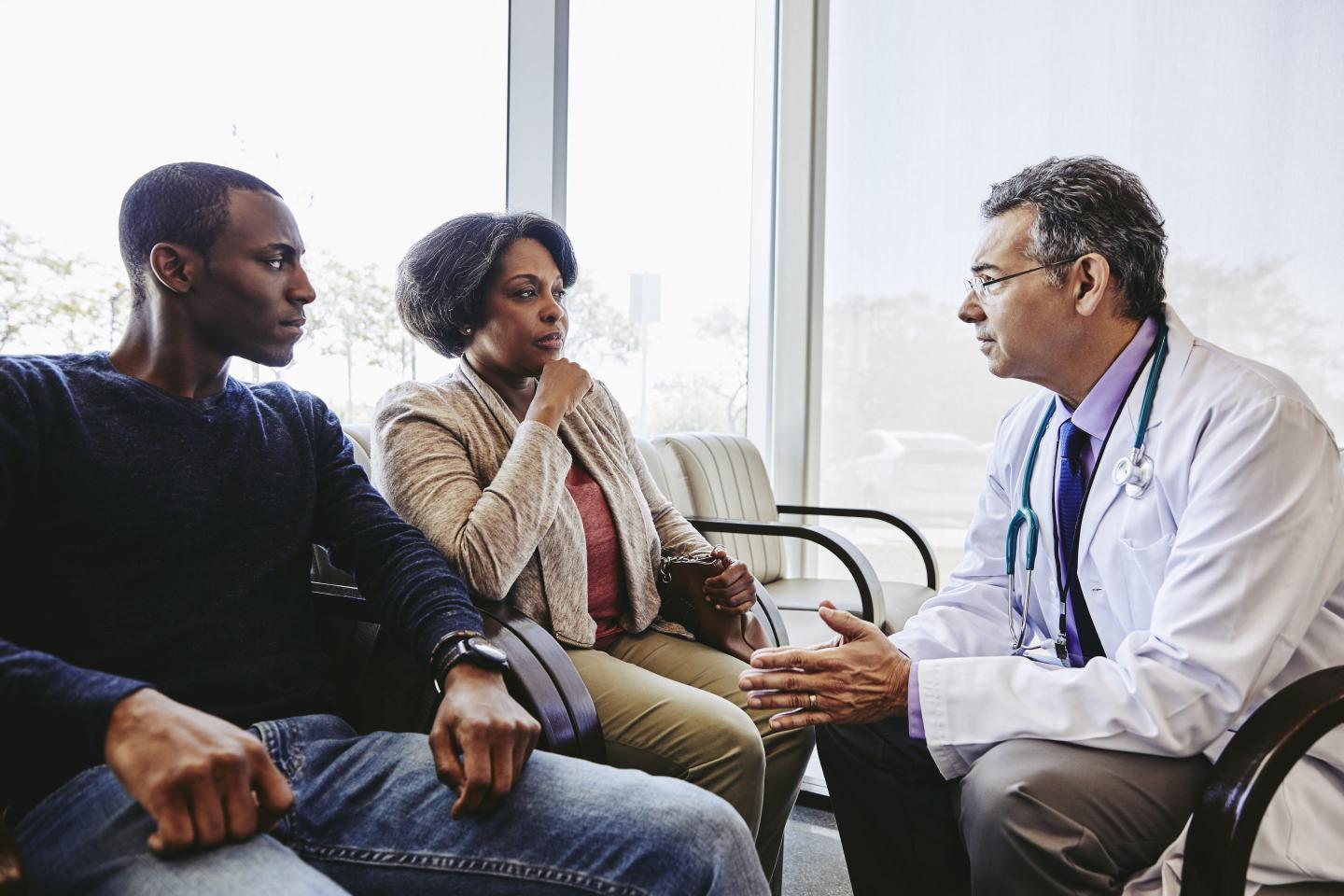 doctor talking to family in hospital lobby