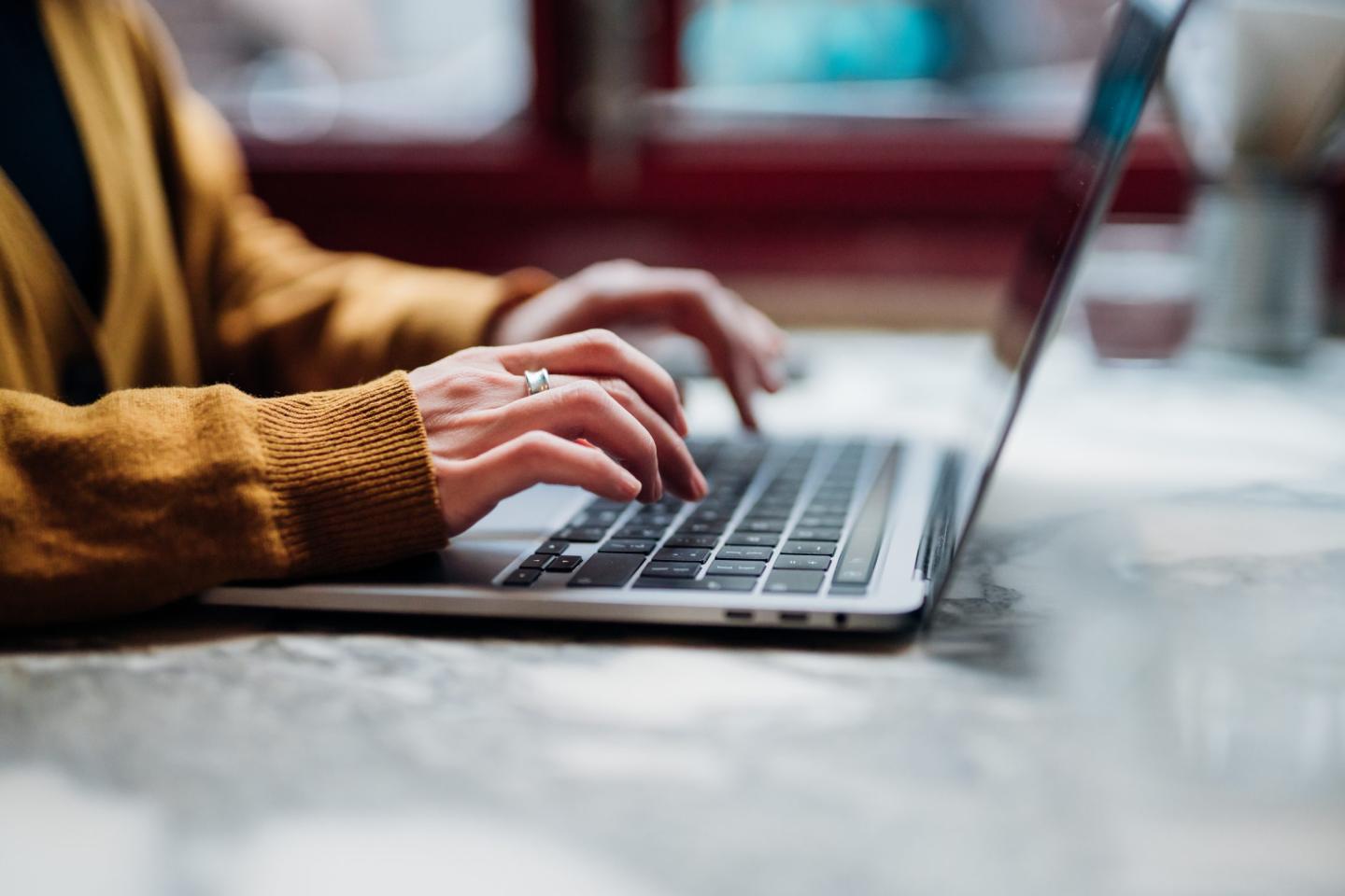 Woman typing on her laptop