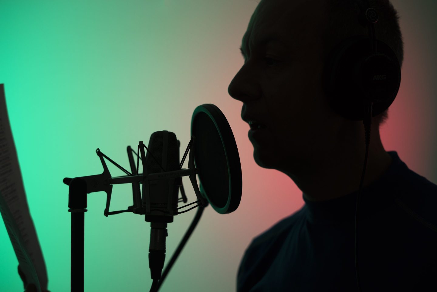 A voice actor in a studio with a microphone