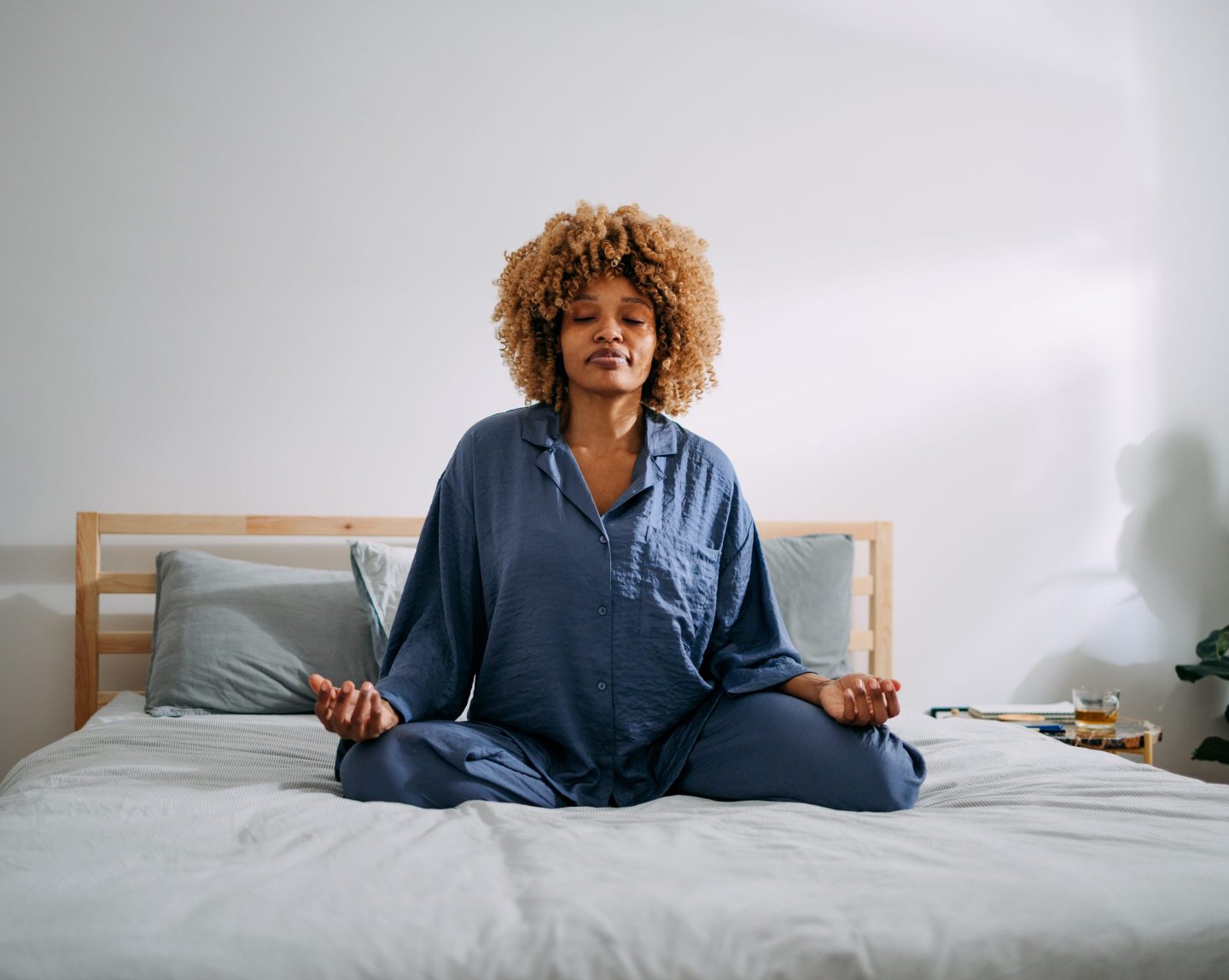 Woman meditating on bed