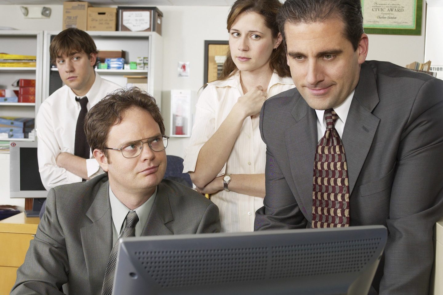 The Office characters at a computer