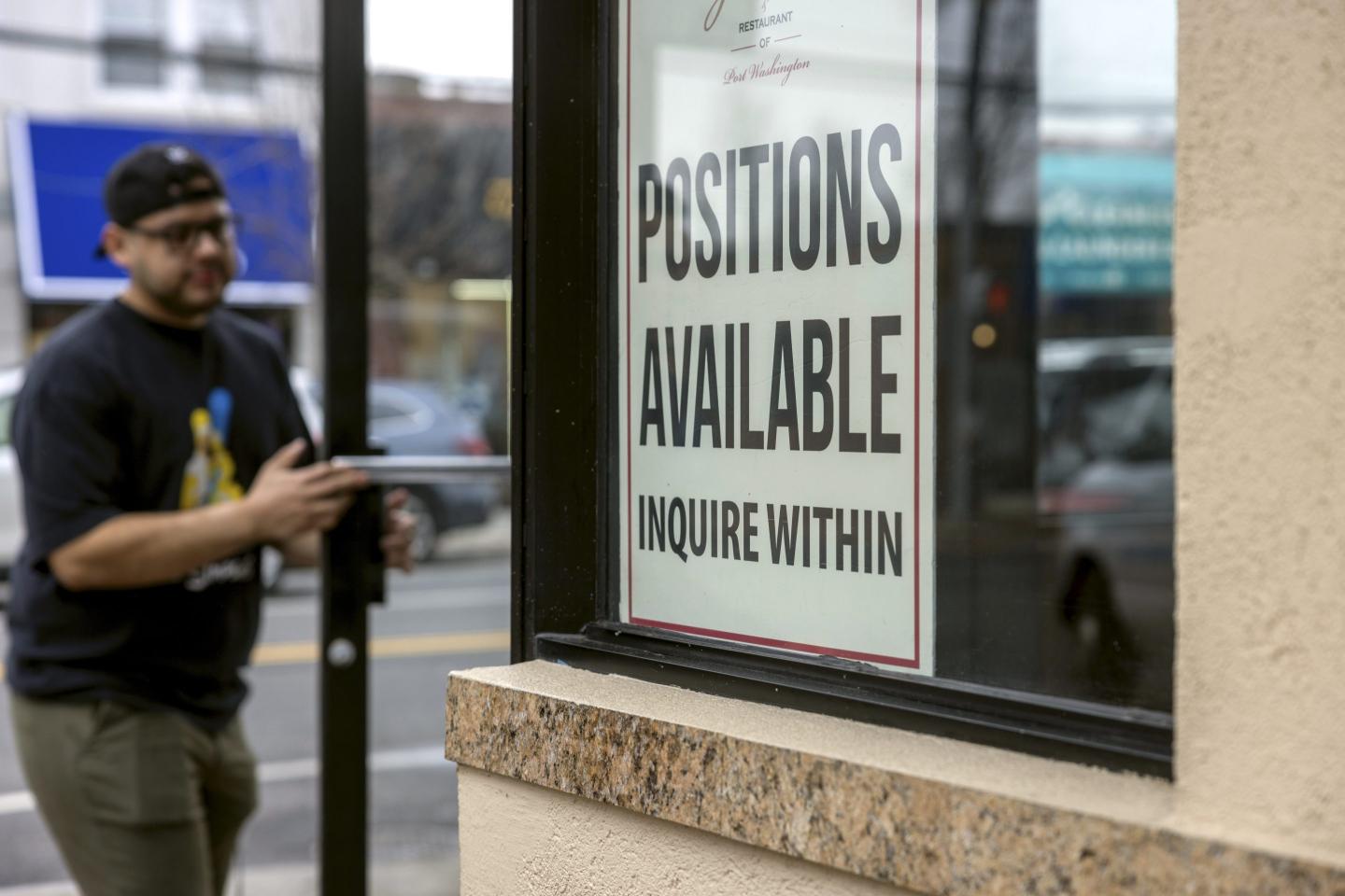 Port Washington, N.Y.: A Help Wanted sign seeking workers is on a window at Gino's Pizzeria and Restaurant on Main Street in Port Washington, New York, on January 5, 2022.