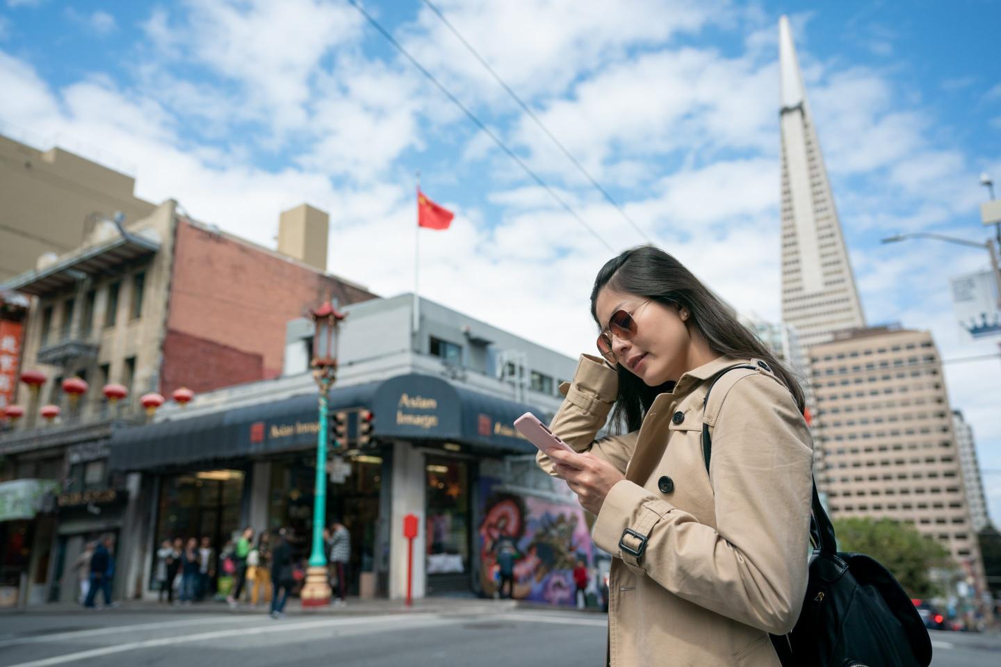 Woman traveler navigating with the use of her cell phone
