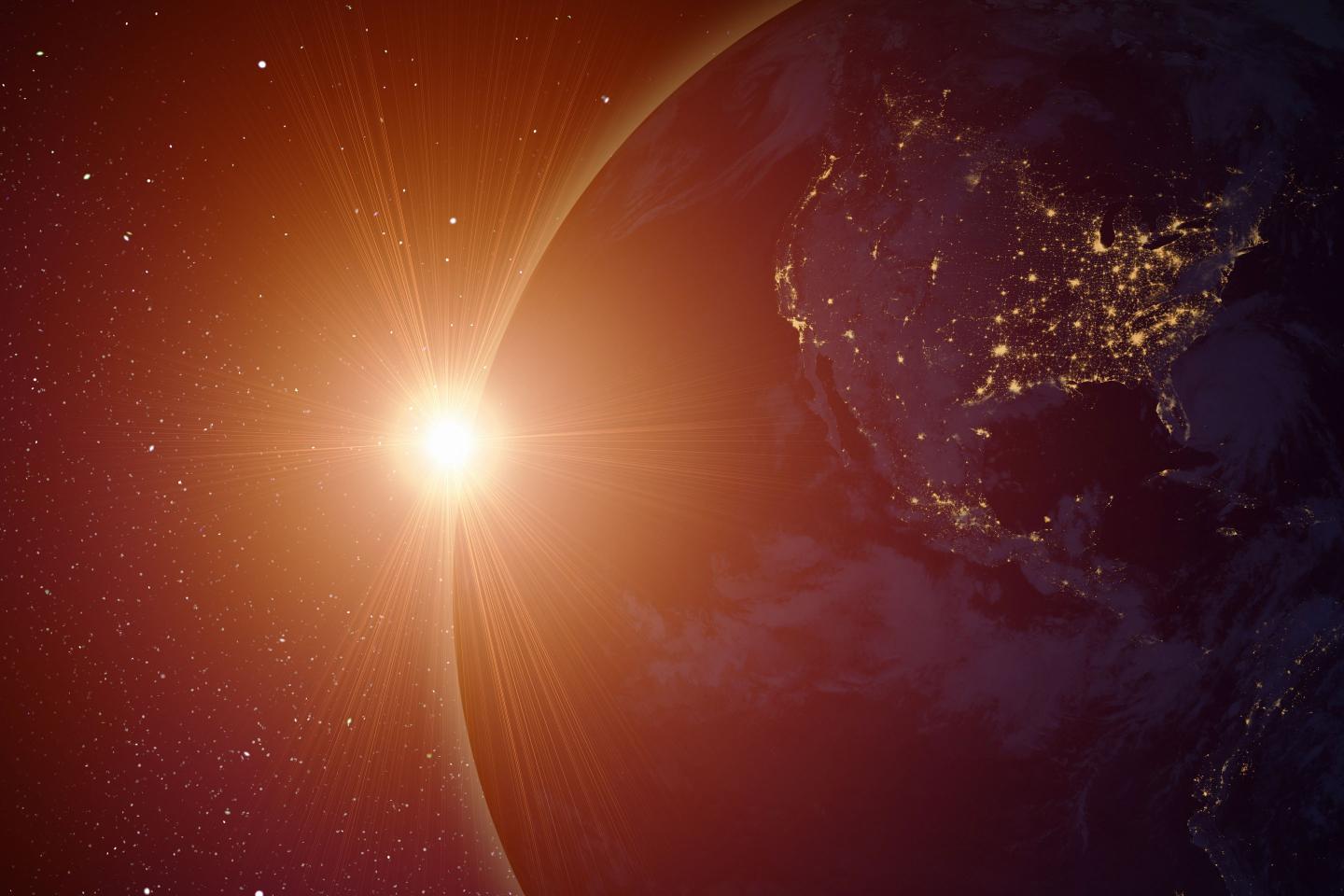 Rising sun behind planet earth