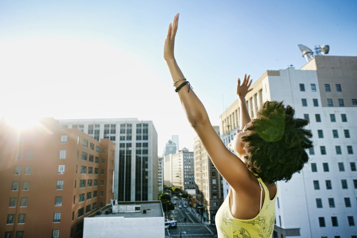 Woman on a rooftop surrounded by other buildings