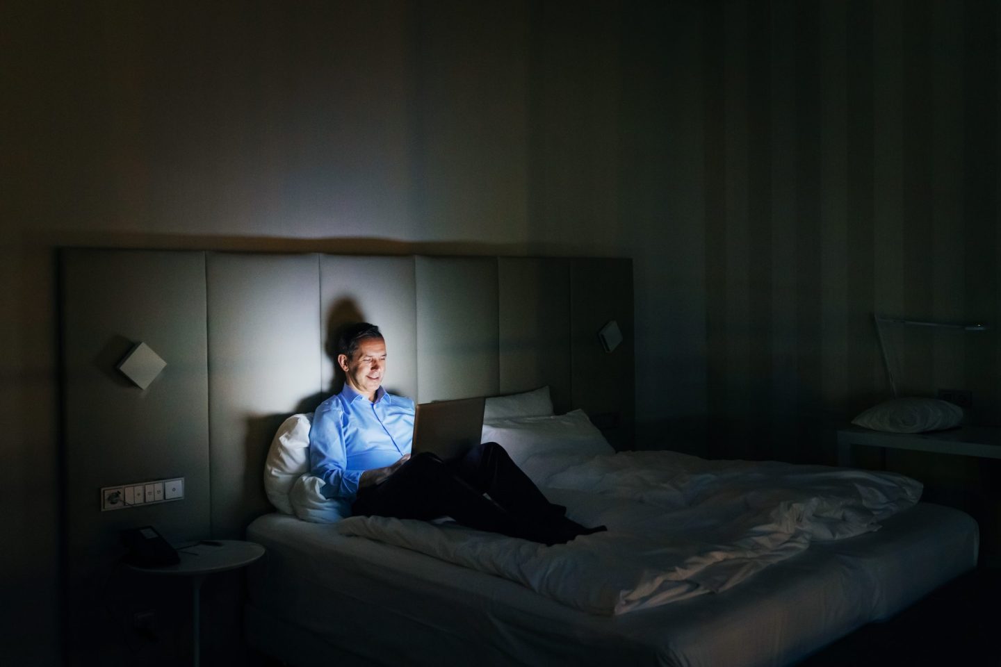 Businessman Working Late In Hotel Room