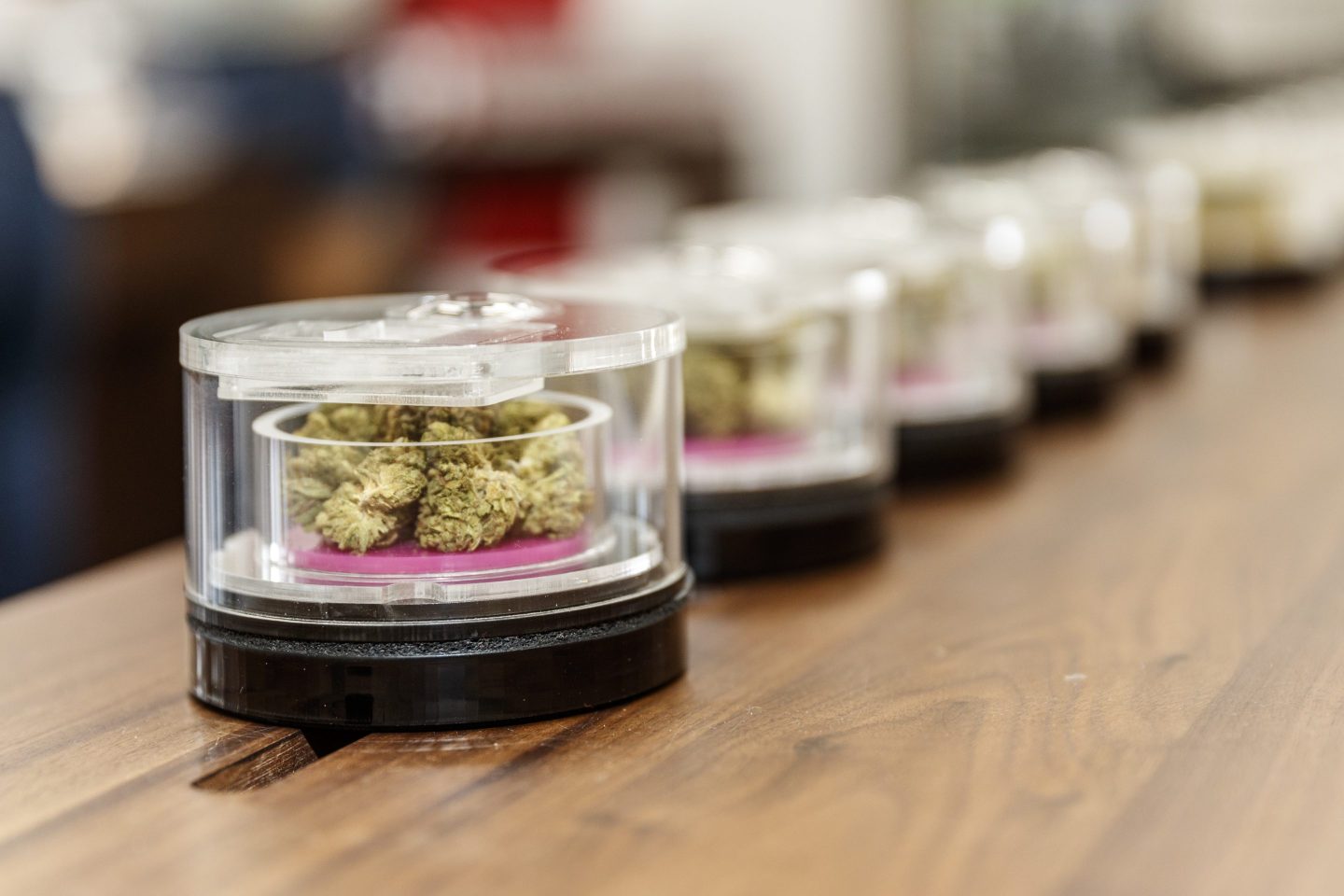 Marijuana in see-through containers is displayed for sale