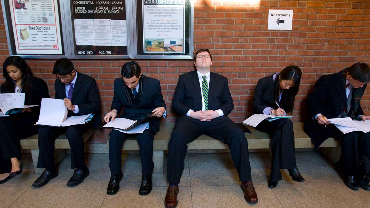 people in suits waiting to be called in for a job interview