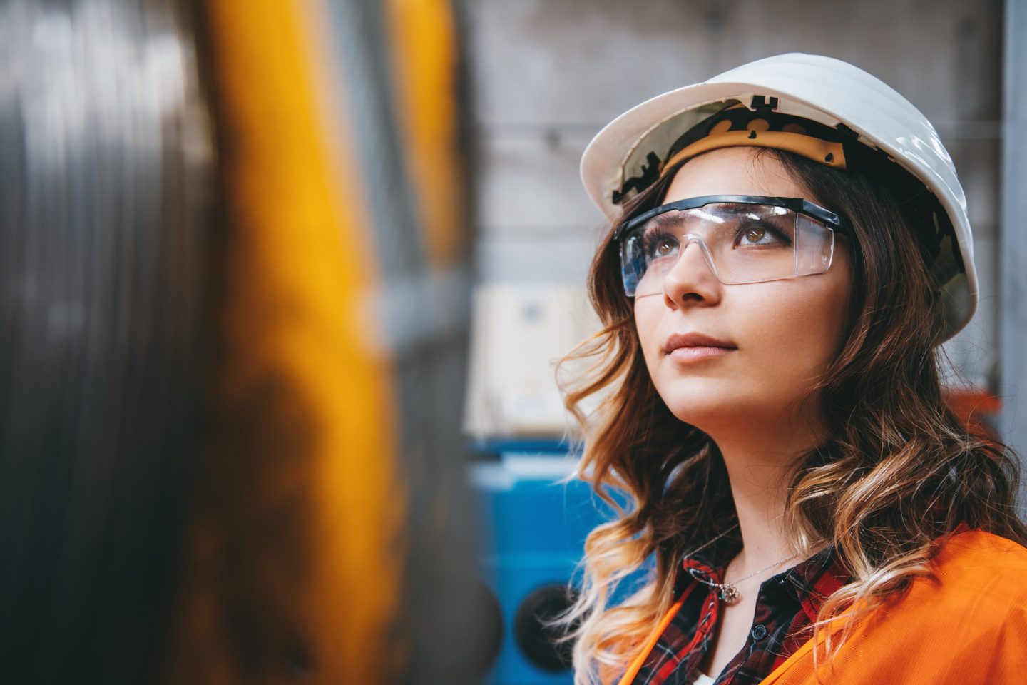 Portrait of young woman with white helmet looking up