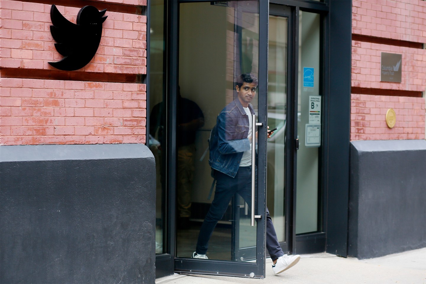 A man exits Twitter Headquarters on October 28, 2022 in New York City.