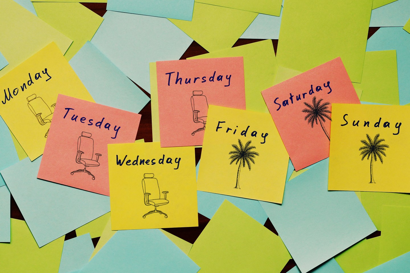 Days of the week written on multicolored stickers.