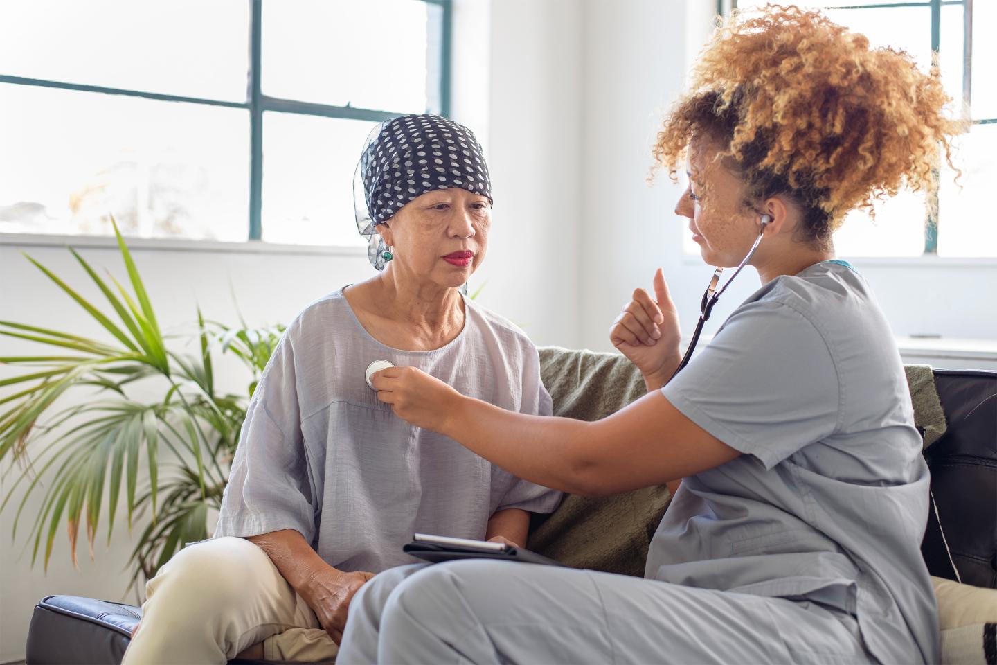 Home health nurse providing care for patient